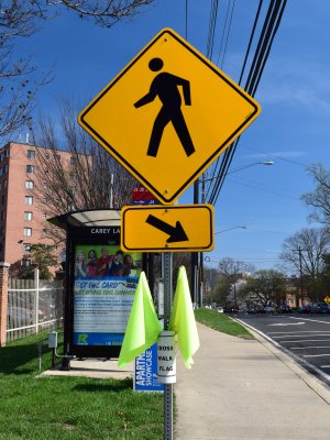 Warning sign with a cup containing some yellow flags.