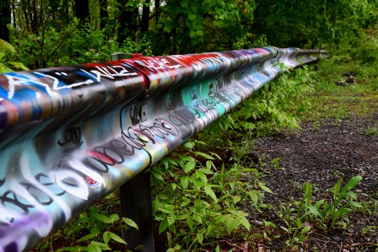 Graffiti-covered guardrail.