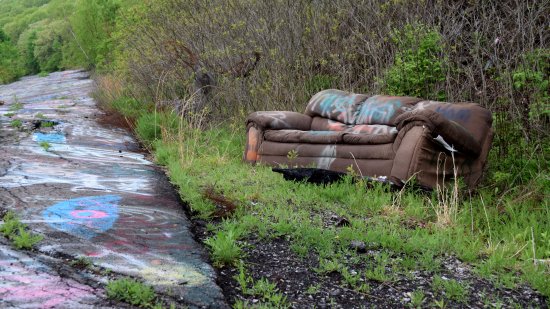 A couch, abandoned on the side of the road, and also covered with graffiti.  Surprisingly, this was not the only abandoned couch that I found here.