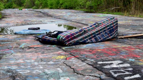 Another abandoned couch.  This one is a sleeper sofa, and is in a more advanced state of decay, considering that the one side has more or less melted away.