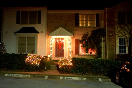 On the other side of my neighborhood, some simple white lighting around the door, and what looks like a blanket of lights on the hedges.