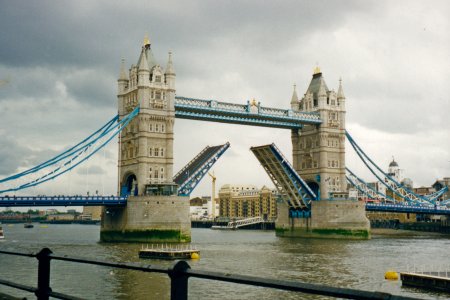 Tower Bridge, with the deck raised in order to allow a boat with a tall mast to pass through.