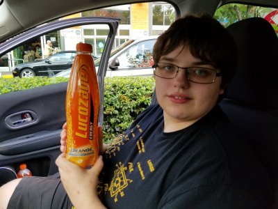 Elyse holds a bottle of Lucozade