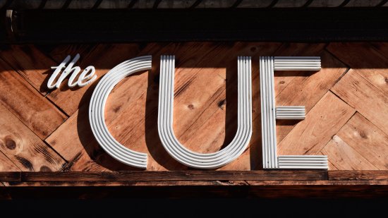 Sign for The Cue, which is a Christianity-focused meeting space.  I don't think that the sign is necessarily vintage, but the wood backdrop and fonts definitely threw back to an older period.