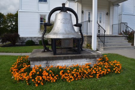Bell in front of First Baptist Church.