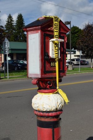 Municipal fire alarm box at North Main and Madison Streets.  Cortland previously had a municipal fire alarm box system, but that system is now in the process of being decommissioned.  Note the "not in service" tape over the handle.