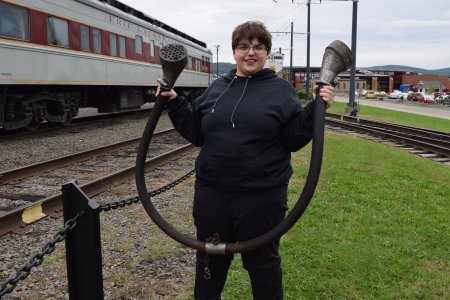 Elyse holds up a communications cable that she found on the ground.