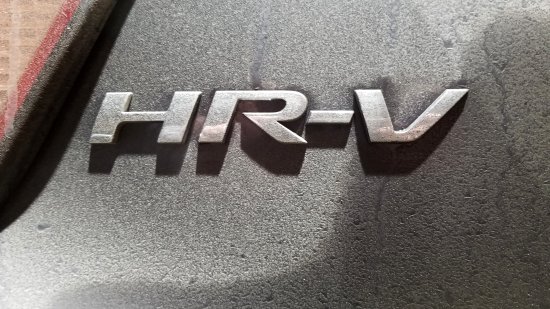 HR-V badging on the back hatch, encrusted with all kinds of dirt.