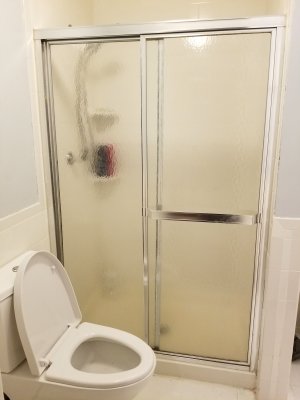 The shower doors, moments before being dismantled