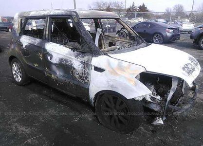 Right front view.  I imagine that this side, with its heavy smoke and fire damage, is what led the auction site to list the car's color as "black" instead of green.