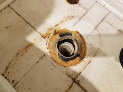 With the toilet gone, we made a surprising discovery: there were three wax rings under there.  Yes, three.  They went out, too.
