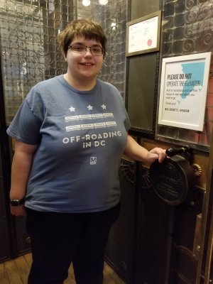 Elyse poses with the controls for the manual elevator at the Gladstone Hotel.