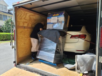 The delivery guy gets the machine off of the truck.  I was surprised to see that it traveled next to an Acura TLX.  That car was going to Florida.
