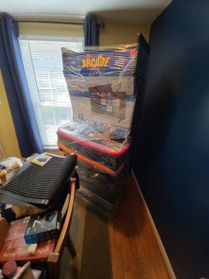 The arcade machine, safe and sound in the living room, still wrapped up.  And yes, those are pool noodles being used as bumpers.