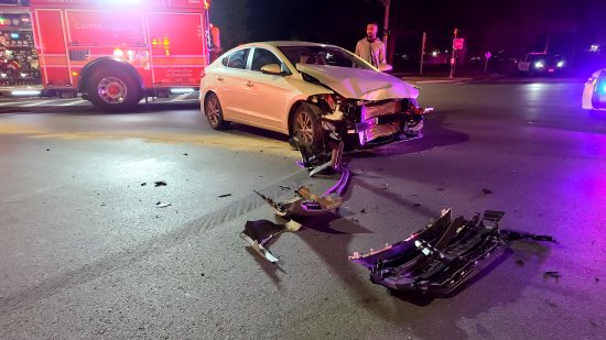 The other vehicle, a Hyundai Elantra, in the middle of Montgomery Village Avenue, with its front smashed in, and debris scattered in front of it.