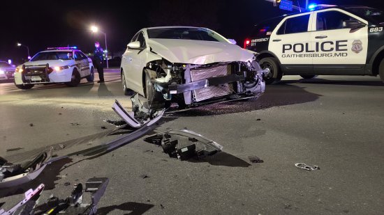 The other vehicle, a Hyundai Elantra, in the middle of Montgomery Village Avenue, with its front smashed in, and debris scattered in front of it.