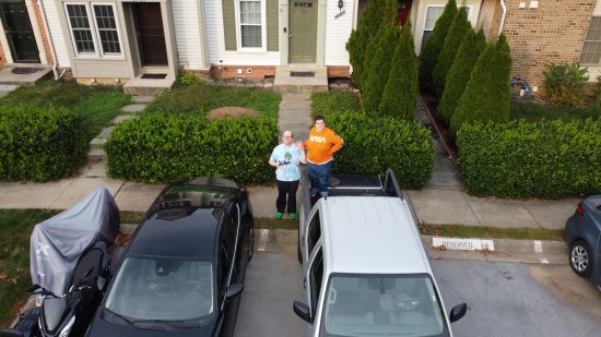 Drone selfie of Elyse and me.  Elyse is standing in the bed of a silver Nissan Frontier, which is the rental car that I have with the HR-V still in the body shop (it should be back later this week).