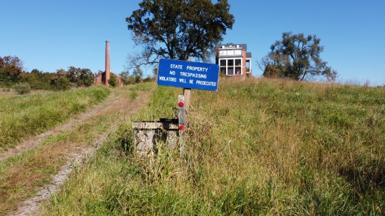 The "No Trespassing" sign at the edge of the property, still photographed with the drone, just before landing