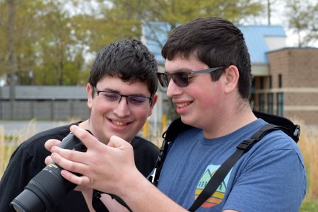 Aaron and Evan look at the shots that Evan took.