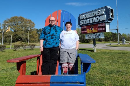 Evan got a photo of Elyse and me standing in the adirondack chair on the line between the two states.