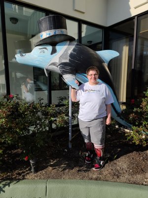 Elyse poses with a dolphin in front of one of the hotels along the strip.