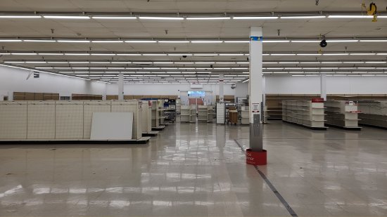 The easternmost (right-side) third of the store was closed off by using shelving to form a wall.  I guess that if you're going to be this light on merchandise to begin with, you might as well condense the store down a bit by blocking off sections of it.  Somewhat ironic to block off a section of the store, though, considering that based on the appearance of the roof, this store was expanded to the west at some point during the 1990s.