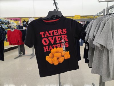 Kid-sized shirt in the clothing section, reading "taters over haters".