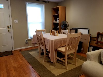 The dining side of the living room on July 31, 2018, after we put a new area rug down and bought some unfinished furniture.