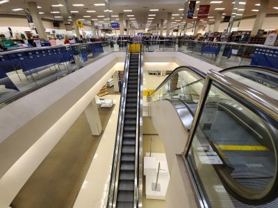 Escalators going down to the lower level, shut off and barricaded.  Only the far end of the lower level (furthest from the camera) was accessible to customers via a stairway and an elevator for access to the portrait studio and the restrooms.