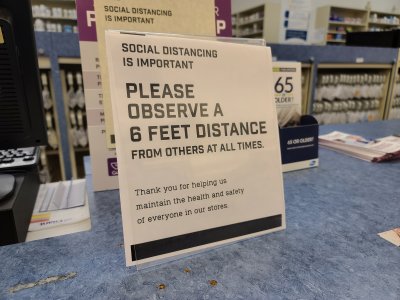 Sign at the pharmacy at Giant Food asking people to be socially distant.