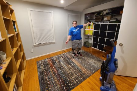 Elyse poses for a photo in the back bedroom, after we got it cleaned up and back to normal