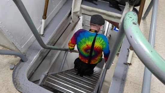 Navigating a narrow, steep stair between decks on the Wisconsin.