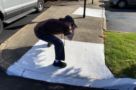 Evan got this shot of me photographing a discarded slice of pizza outside of a building in Virginia Beach.