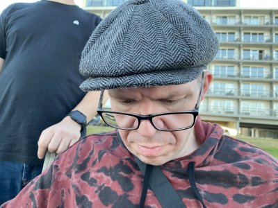 Looking at the drone remote while sitting on a bench on the Virginia Beach boardwalk, with a somewhat perturbed look on my face.