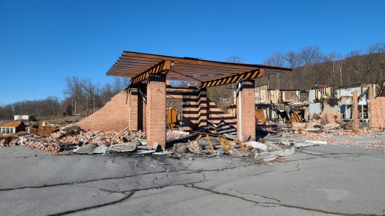 What remains of the canopy now stands alone, as the structure behind it is completely gone.