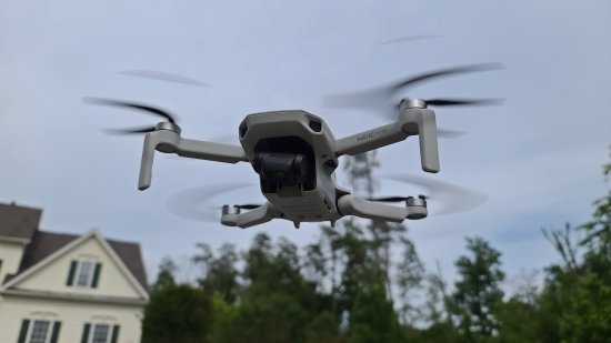 DJI Mavic Mini in flight. Note that the camera is cocked to one side.