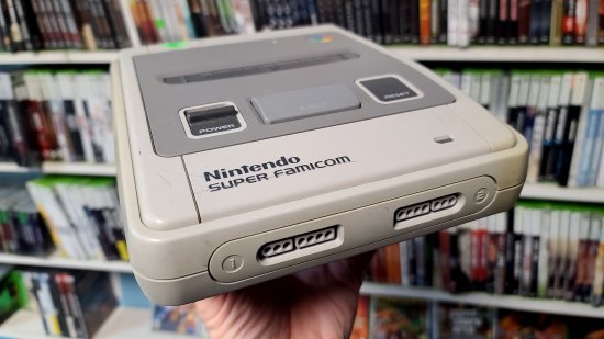 A Japanese Super Famicom console.  This was marketed as the Super Nintendo outside of Japan, and had a different exterior design in North America.