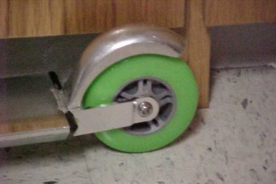 The rear wheel of the scooter, showing the brake