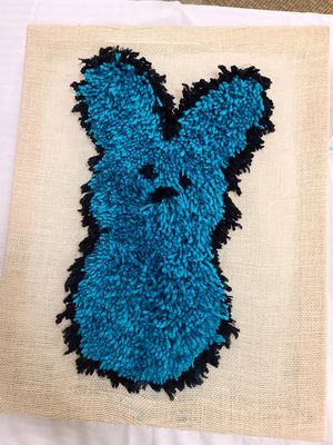 Yarn Peep sewn into a piece of fabric.