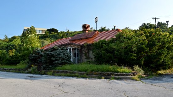 The Howard Johnson's restaurant was quite overgrown once again.  Apparently, it gets like this from time to time, as it was overgrown in 2013, then it got cut back, and now it's overgrown again.  But it's still a far cry from what it looked like when I first photographed it in 2003.