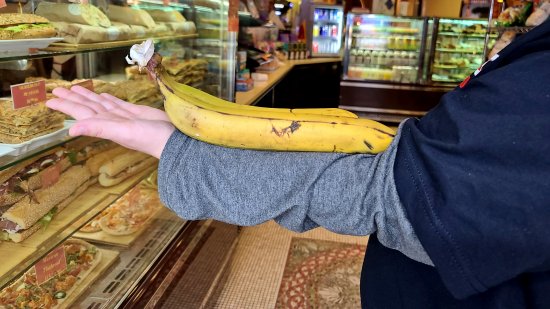 Elyse shows off the really big bananas that we found at Tazza Cafe that we got for later.