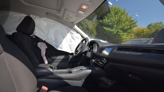 The front seats, with the deployed side airbags.