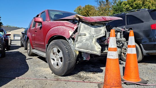 The red Nissan Pathfinder that ran into me, parked in front of my car