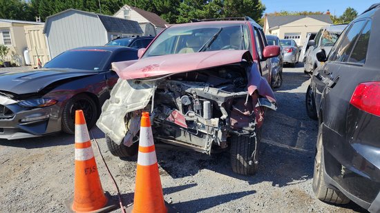 The red Nissan Pathfinder that ran into me, parked in front of my car