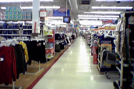 Back action alley.  Note that the carpet had been pulled out of the softlines areas and replaced with the fake wood flooring, though the red floor stripe around the softlines area remained.