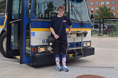 Elyse poses for a photo in front of bus 97.