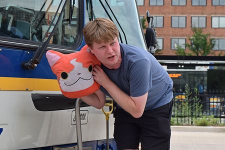 Brian poses for a photo with Kitty in front of bus 97.