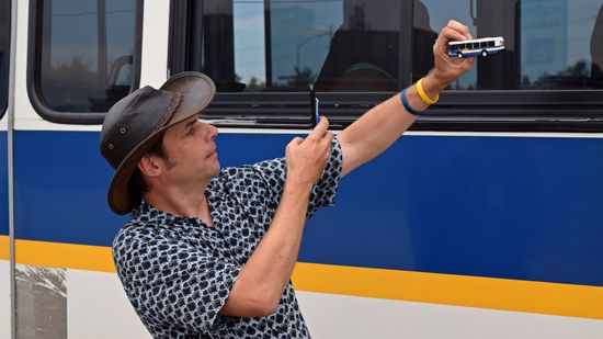 Fred gets photos of the model bus with the full-size bus.