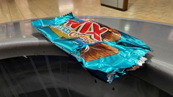 Elyse got a salted caramel Twix, and we shared it between the three of us (it was good, by the way).  Afterward, I photographed the wrapper before throwing it away.  The phrase "looking over the abyss" came to mind as I photographed this, as the wrapper was perched on the rim of the can before I pushed it in.