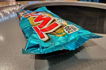 Elyse got a salted caramel Twix, and we shared it between the three of us (it was good, by the way).  Afterward, I photographed the wrapper before throwing it away.  The phrase "looking over the abyss" came to mind as I photographed this, as the wrapper was perched on the rim of the can before I pushed it in.